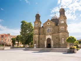 Photo of aerial view of The Cathedral of the Assumption and Varna city at amazing sunset, Bulgaria.