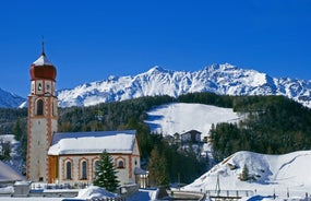 Photo of The mountain village at the Austrian ski resort Soelden on a cold and sunny winter day.