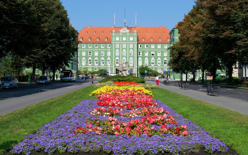 Photo of vibrant gardens leading up to the City Council of Szczecin.