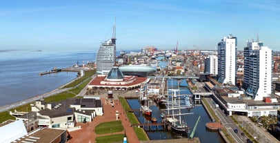 Photo of aerial view of the city of Bremerhaven with the harbor and traditional sailing-ships, Germany.