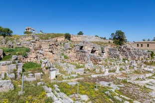 Photo of temple of Apollo with Acrocorinth in the background. Ancient Corinth, Greece.