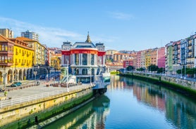 Photo of aerial view of Vizcaya bridge over the river and cityscape at Portugalete, Spain.