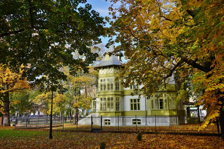 Photo of old green wooden house in skansen in Lodz.