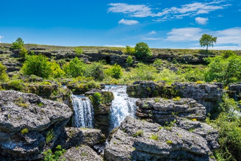 Photo of stunning waterfalls in rocky green scenery at Niagara falls landmark in Podgorica city, Montenegro.