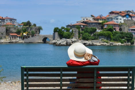 photo of a tourist enjoys the view of Amasra and Kemere Bridge in Turkey.