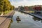 photo of La Villette Park with the Canal of the Basin of the Villette with boat at beautiful morning in Paris, France.