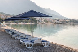 Photo of panorama and landscape of Makarska resort and its harbour with boats and blue sea water, Croatia.