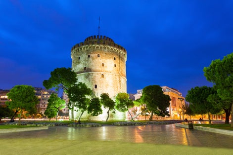 Photo of White tower at night in Thessaloniki, Greece.