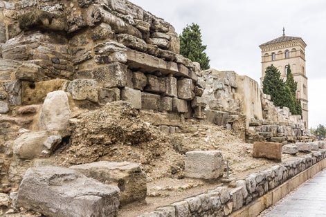 Photo of Roman Walls in downtown: Avenida Cesar Augusto (2nd - 3rd centuries A.D.). There is a fortified tower followed by walls. These were used to defend the city during the Middle Ages. Zaragoza, Spain.