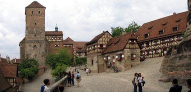 Photo of scenic summer view of the German traditional medieval half-timbered Old Town architecture and bridge over Pegnitz river in Nuremberg, Germany.