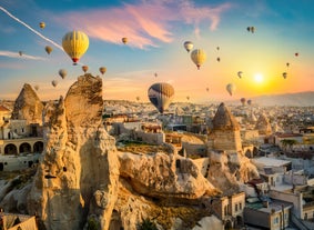 Hot air balloons flying over Uchisar Castle. Cappadocia. Nevsehir Province. Turkey.