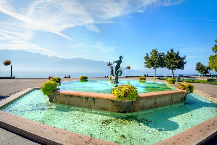 Photo of beautiful fountain on seafront in Vevey town, Lake Geneva, Vaud canton, Switzerland.