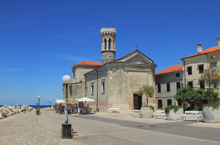 Photo of Embankment, church and beacon. Piran, Slovenia.