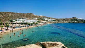 Photo of panoramic aerial view of the popular Platis Gialos beach on the Greek island of Mykonos with turquoise sea, Greece.