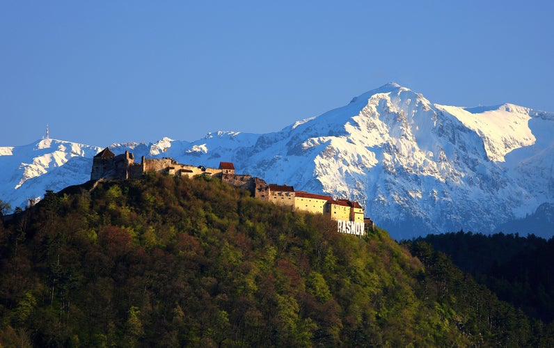 Medieval fortress (citadel) in Rasnov, Bucegi mountain in background