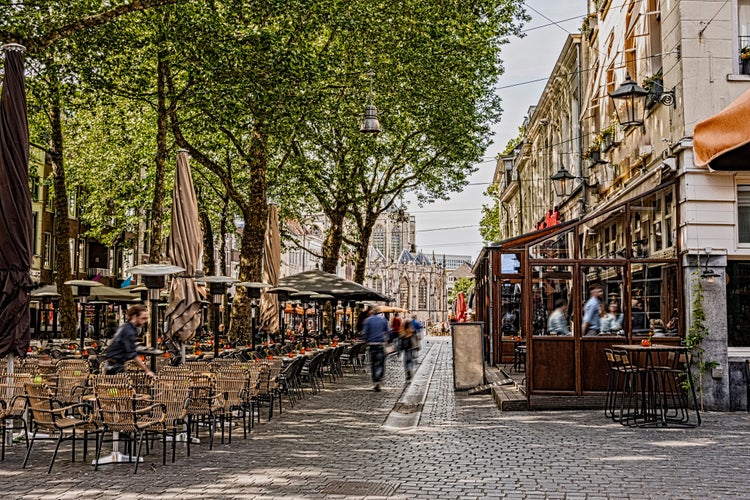 photo of view of walk and restaurant terraces in the center of the city of breda in the background you can see the great church. Netherlands N.