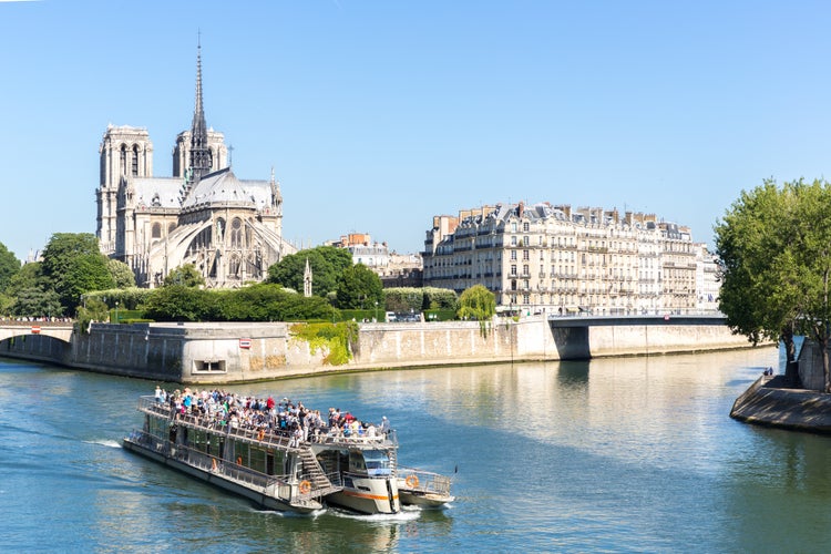 Photo of tourist cruise in River Seine Paris with Cathedral Notre Dame Reims Champagne, France.