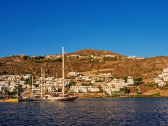 Photo of aerial view to the popular bay of Ornos on the island of Mykonos, Greece.