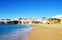 Photo of wide sandy beach in white city of Albufeira, Algarve, Portugal.