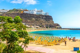 photo of landscape with Maspalomas town and golden sand dunes at sunrise, Gran Canaria, Canary Islands, Spain.