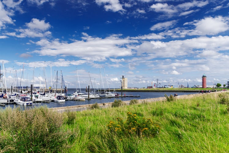 Photo of waterfront in Cuxhaven, Germany with lighthouse in background.