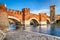 photo of view of Verona, Italy. Scenery with Adige River and Ponte Scaligero and Castelvecchio, medieval landmarks of veronese city, Verona, Italy.