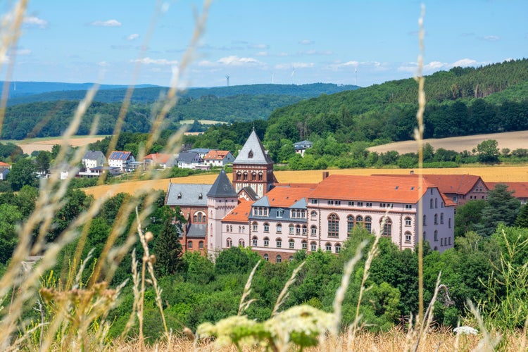 Photo of the mission house with church and the landscape of the Sankt Wendler,Germany.