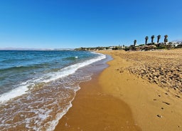 Photo of aerial view of Malia beach and small island with Church of Transfiguration, Heraklion, Crete, Greece.