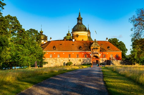 photo of tourists in the entrance of Gripsholm Castle on a clear blue day in Mariefred, Sweden.
