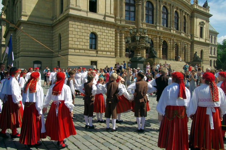Folk dancers in traditional costumes performing in a public square during Prague Folklore Days in Czechia in July..jpg