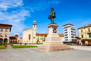 Photo of Italy Piazza Maggiore in Bologna old town tower of town hall with big clock and blue sky on background, antique buildings terracotta galleries.