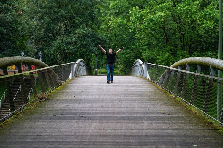 Man walking over a pedestrian bridge at Peterbos, Anderlecht, Brussels Capital Region, Belgium