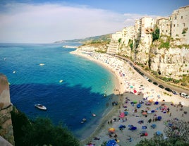 photo of an aerial view of Parghelia in Italy. Overview of seabed seen from above, transparent water and beach with umbrellas.