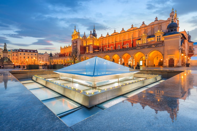 Photo of cloth Hall Sukiennice building at night on main square of Krakow city, Poland.