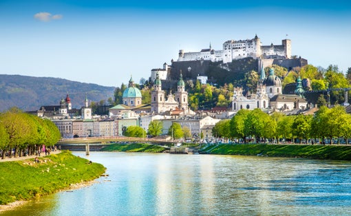 Photo of beautiful view of Salzburg skyline with Festung Hohensalzburg and Salzach river in summer, Salzburg, Salzburger Land, Austria.