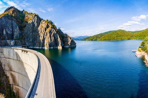 Photo of Vidraru Dam built to create an artificial reservoir lake for hydro electricity production in Fagaras Mountains, Romania.