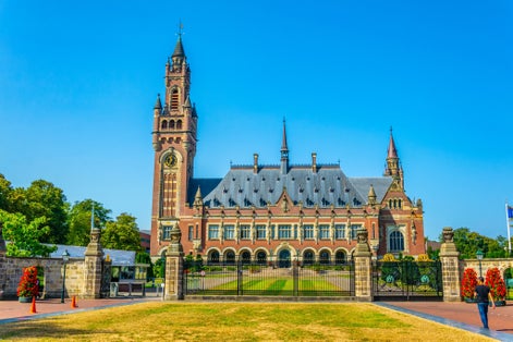 photo of man on Vredespaleis, seat of the international court of justice in the Hague, Netherlands.