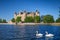View of the Schwerin medieval castle from the lake with swans, Germany.