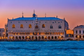 Famous buildings, gondolas and monuments by the Rialto Bridge of Venice on the Grand Canal, Italy.