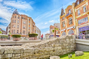 Photo of Saint Anastasia Island in Burgas bay, Black Sea, Bulgaria. Lighthouse tower and old wooden buildings on rocky coast.