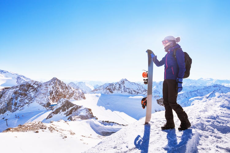 photo of young woman with snowboard, winter holidays in Innsbruck, Austria.