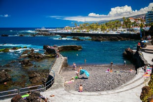 Photo of aerial view with Puerto de la Cruz, in background Teide volcano, Tenerife island, Spain.