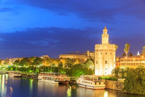 Photo of Golden Tower (Torre del Oro) of Seville, Andalusia, Spain over river Guadalquivir at sunset .