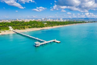 Photo of Saint Anastasia Island in Burgas bay, Black Sea, Bulgaria. Lighthouse tower and old wooden buildings on rocky coast.