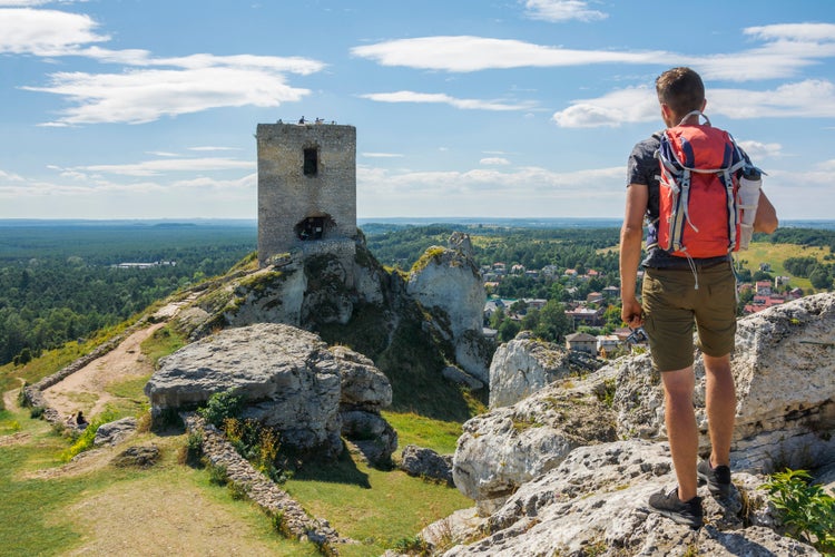 Young traveler exploring ruins of the Olsztyn castle located in the Polish Jura within the Eagles' Nests Trail, Olsztyn, Poland