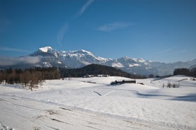 photo of Elevated, scenic view of the town of Bischofswiesen, Bavaria, Germany. The Watzmann Mountain, part of the Bavarian Alps rises into a majestic skyline. A green, spring landscape set in the valley.