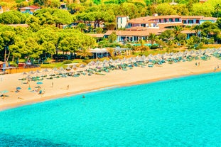 Photo of aerial view of a beautiful bay with azure sea from top of a hill, Villasimius, Sardinia island, Italy.