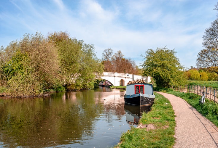 Photo of narrow boat moored at the river Gade, Cassiobury Park, Watford, England.