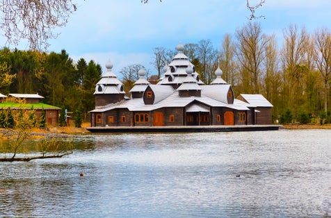 Photo of wooden ancient asian style temple, lake and trees in Pairi Daiza, Belgium.