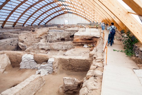 photo of people visits Neolithic Site of Çatalhöyük. UNESCO World Heritage Site. Catalhoyuk is oldest town in world with large Neolithic & Chalcolithic best preserved city settlement in Cumra, Konya, Turkey.